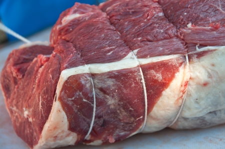 Tying off rolled beef roastsの写真素材