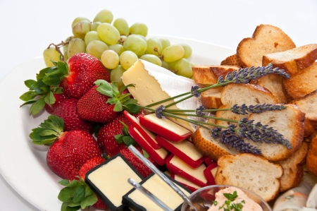 Plate of strawberries, cheeses and grapesの写真素材