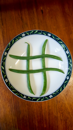 Four beans on a plate in tic tac toe designの写真素材