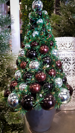 Christmas tree with baubles in silver and deep maroon colorsの写真素材