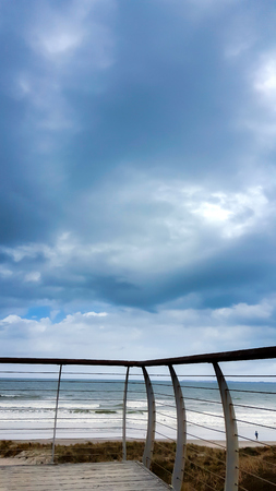 Overcast stormy clouds at the beach rain coming の写真素材