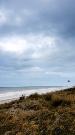 Overcast stormy clouds at the beach rain coming の写真素材