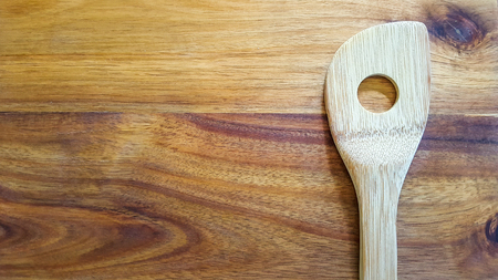 Wooden Spoon on a wooden cutting boardの写真素材
