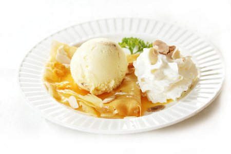 ice cream scoop decorated with crepe and whipping creamの写真素材