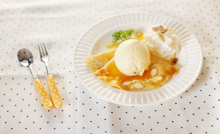 ice cream scoop decorated with crepe and whipping creamの写真素材