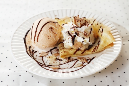 ice cream scoop decorated with crepe and chocolate sauceの写真素材