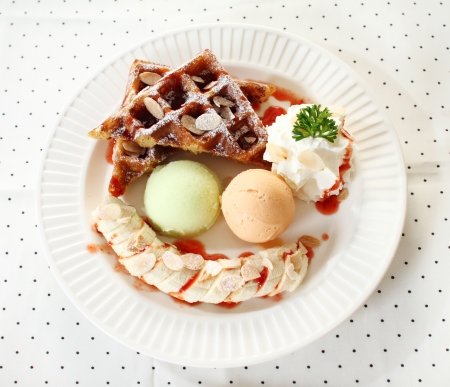 ice cream scoop decorated with waffle and bananaの写真素材