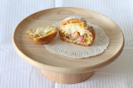 Cream choux on wooden trayの写真素材