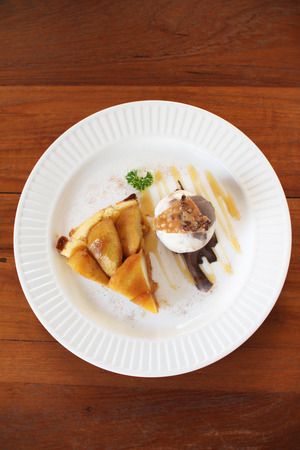 warm apple tart with ice cream scoopの写真素材