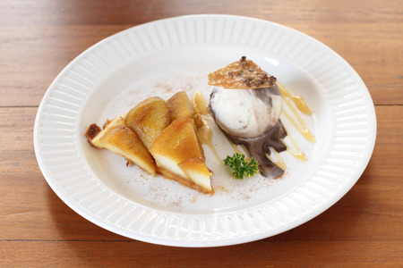 warm apple tart with vanilla ice creamの写真素材