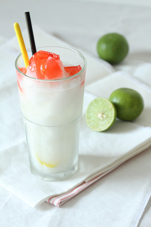 a glass of lime smoothies drinks with red jellyの写真素材