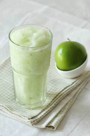 fresh apple smoothies drinks on white backgroundの写真素材