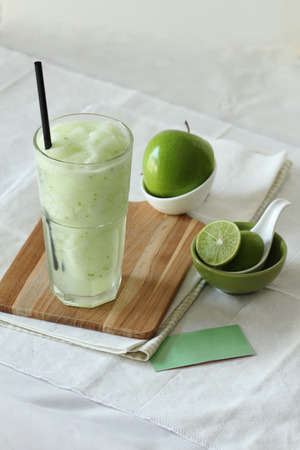 fresh apple smoothies drinks on white backgroundの写真素材