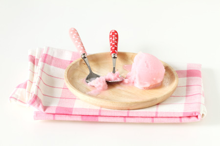 pink ice cream in wooden plate on white backgroundの写真素材
