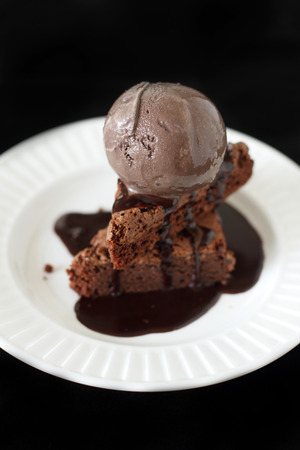 chocolate ice cream on slices of  a brownie の写真素材
