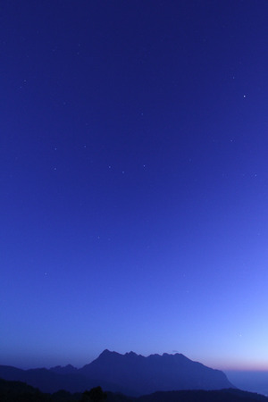 mountain under starry deep blue night skyの写真素材