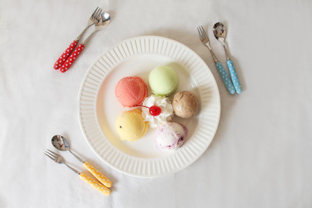 colorful ice cream scoops on white plate white backgroundの写真素材