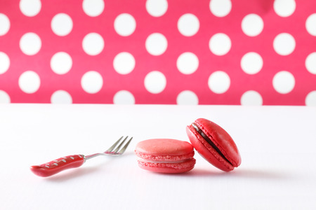 Sweet and colourful french macaroons on polka dot background 
の写真素材