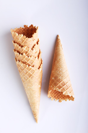 row of empty ice cream cones on white backgroundの写真素材