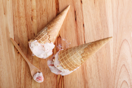ice cream cones dropped on wooden backgroundの写真素材