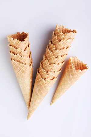 row of empty ice cream cones on white backgroundの写真素材