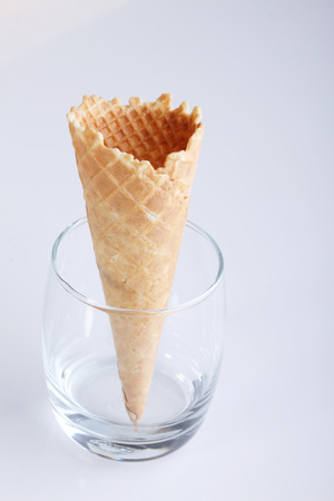empty ice cream cones in clear glasses on white backgroundの写真素材