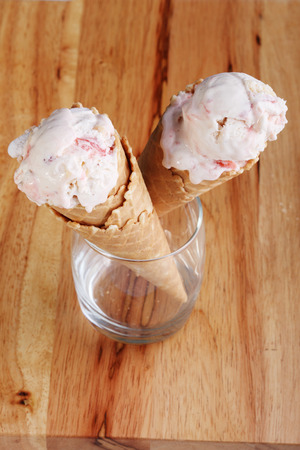 ice cream cones in a  clear glass on wooden backgroundの写真素材