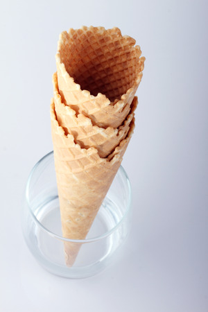 empty ice cream cones in clear glasses on white backgroundの写真素材