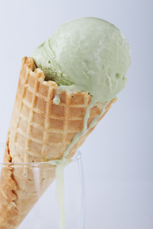 green tea ice cream cones in clear glasses on white backgroundの写真素材