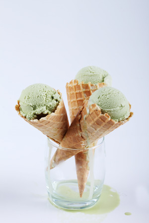 green tea ice cream cones in clear glasses on white backgroundの写真素材