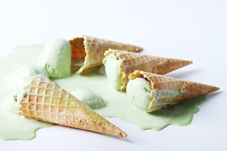 green tea ice cream cones dropped on white backgroundの写真素材