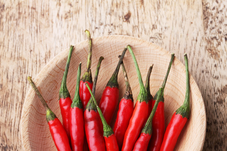 Red Hot Chili Peppers in bowl on wooden backgroundの写真素材