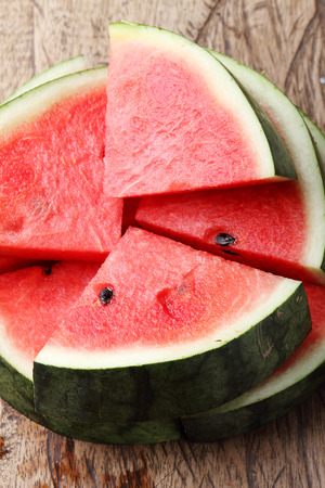 Slices of fresh watermelon on wooden backgroundの写真素材