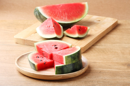 Slices of fresh watermelon on wooden backgroundの写真素材