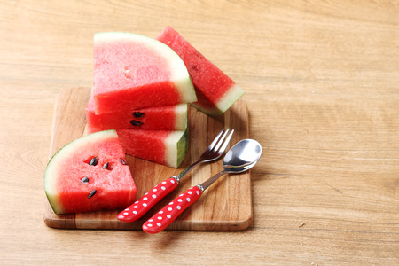 Slices of fresh watermelon on wooden backgroundの写真素材