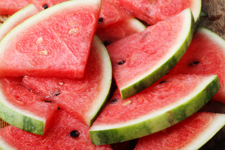 Slices of fresh watermelon on wooden backgroundの写真素材