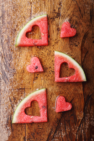 pieces of heart shape watermelon on wooden backgroundの写真素材