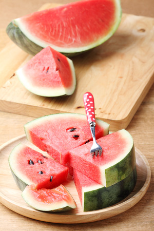 Slices of fresh watermelon on wooden backgroundの写真素材