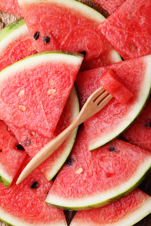 Slices of fresh watermelon on wooden backgroundの写真素材