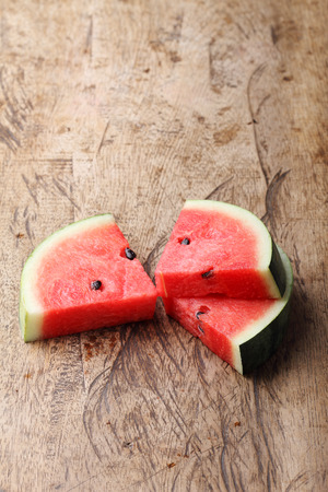 Slices of fresh watermelon on wooden backgroundの写真素材