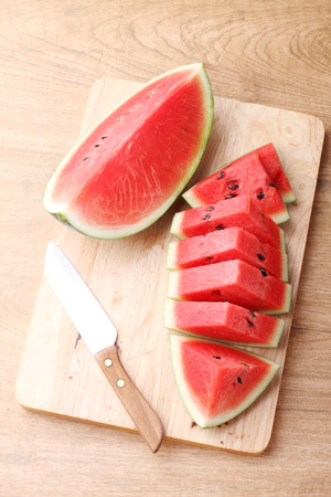 Slices of fresh watermelon on wooden backgroundの写真素材
