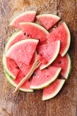 Slices of fresh watermelon on wooden backgroundの写真素材