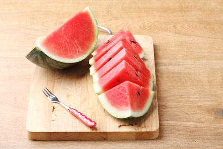 Slices of fresh watermelon on wooden backgroundの写真素材
