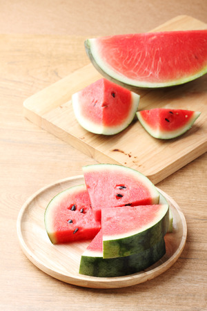 Slices of fresh watermelon on wooden backgroundの写真素材