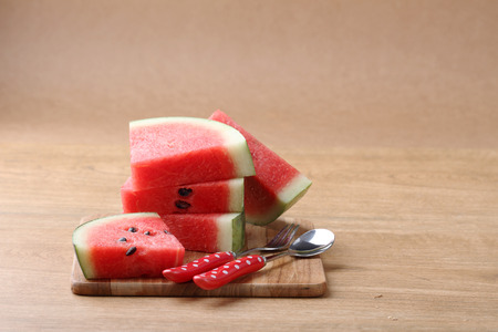 Slices of fresh watermelon on wooden backgroundの写真素材
