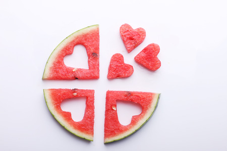pieces of heart shape watermelon on white background with copyspaceの写真素材