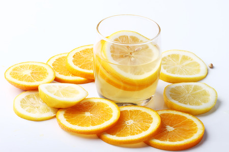 drink and stack of citrus fruits slices. Oranges and lemons. On white backgroundの写真素材
