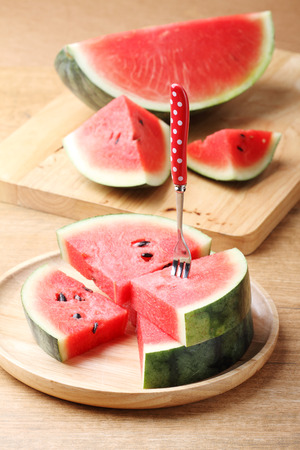 Slices of fresh watermelon on wooden backgroundの写真素材