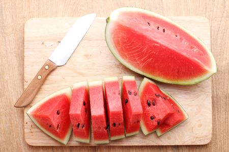 Slices of fresh watermelon on wooden backgroundの写真素材