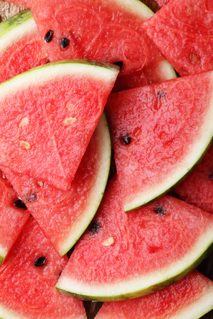 Slices of fresh watermelon on wooden plateの写真素材